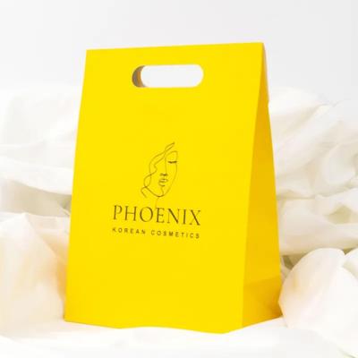 China Clothing Packaging Die Cut Handle Shopping Kraft Paper Bag Customized Yellow Gift Bags Te koop