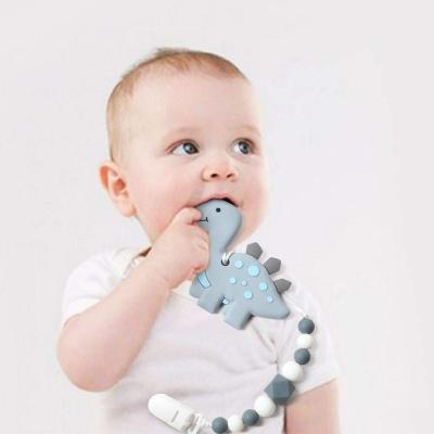 China High Quaity Dinosaur Teething Pain Relief Silicone Teether Infant Girls Boys Funny Baby Teether for sale