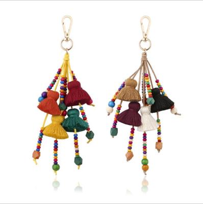 China Gift Boho Style Pompoms Keychains with Colorful Tassel for Women Bag Hanging Wooden Beads Bag Pendant Accessories Jewelry for sale