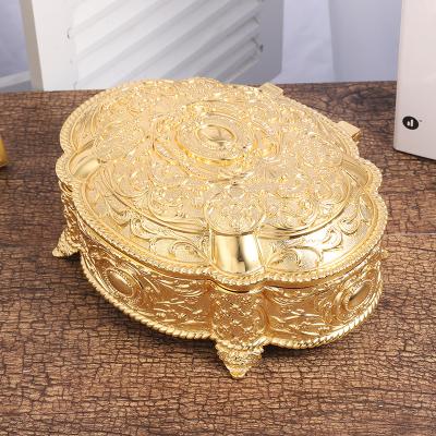 China Jewelery Packaging Nordic Fashion Gold Flip Jewelry Box Necklace Earrings Lightweight Luxury Oval Jewelry Storage Box for sale