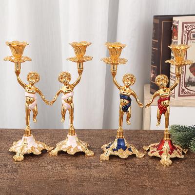 China Luxury European Gold European Style Stand Child Shape Metal Candelabra Candlestick for sale