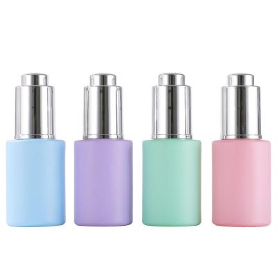 China Luxury Cosmetic Glass Dropper Bottle 30ml Essential Oil Packaging Glass Bottle With Silver UV Press Dropper for sale