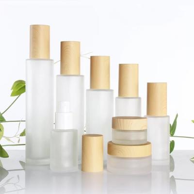 China 20ml 60ml 100ml 50g Glass Bottle Set Cosmetic Lotion Pump/Spray/Toner Vials Set With Wood Grain Lid for sale