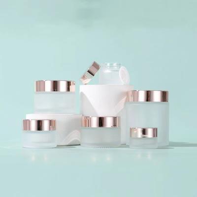 China 5g 10g 15g 20g 30g 50g 100g cosmetic clear frosted cream jar with rose gold lid glass jar for sale