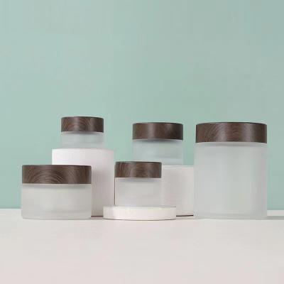 China 5ml 10ml 15ml 20ml 30ml 50ml 100ml Container Frosted Glass Cosmetic Clear Jar With Wood Grain Lid Fo Eyer Face Cream Packaging for sale