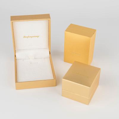 China Recycled Materials Paper Box Mini Square Jewelry Earrings Packaging Box Custom Shiny Gold Printed Logo for sale