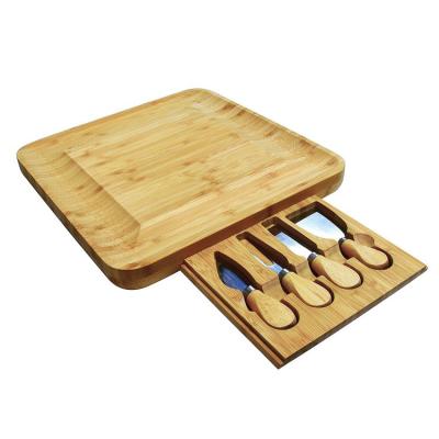 China Sustainable High Quality Bamboo Wooden Pizza Cheese Cutting Board With 4 Knives Tool Kit for sale