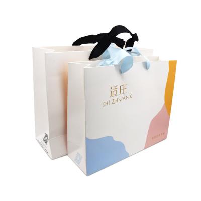 China Custom Recyclable Your Own Logo Printed Recyclable Luxury Paper Bags Packaging Clothing Shopping Paper Bag With Black Ribbon Handle for sale