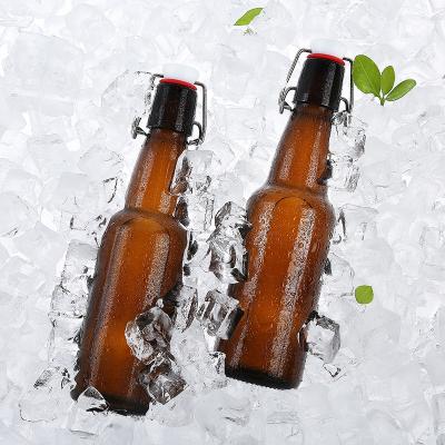 China 11oz Amber Glass Swing Top 330ml Beverage Beer Glass Bottle With Flip Cap for sale