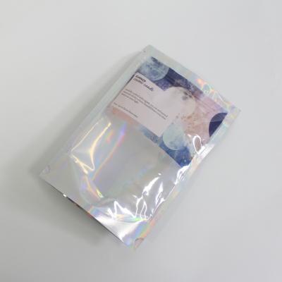 China Moisture Proof Custom Design Transparent Lamination Smell Proof Bags Stand Up Holographic Zipper Lock Pouch Packaging for sale