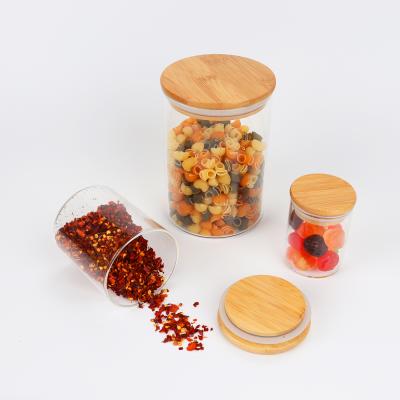 China Eco-friendly recyclable high borosilicate glass food sealed storage jar with bamboo lid for storing coffee beans, snacks, beans, salt, nuts and candy for sale