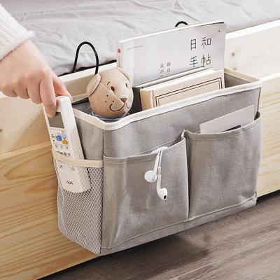 China Sustainable Canvas Bedside Pocket Storage Bag Bedroom Hanging Magazine Toy Storage Box for sale