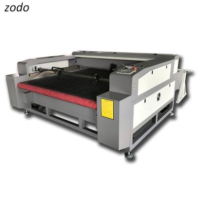 China LASER CUTTER 1600*1000mm 1610 130w 150w 180w Autofeed Cloth Fabric Dual CNC Laser Head Laser Cutting Machine for sale