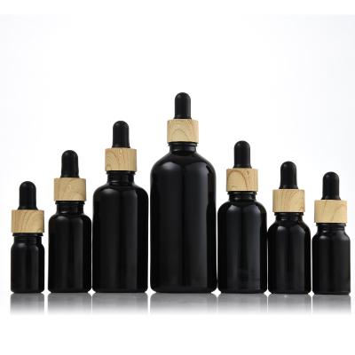 China 30ml Black Personal Care Bottles With A Bamboo Essential Oil Dropper Bottle 20ml Glass Bottles 100ml Black Rubber Bottle 20ml 10ml 5ml for sale