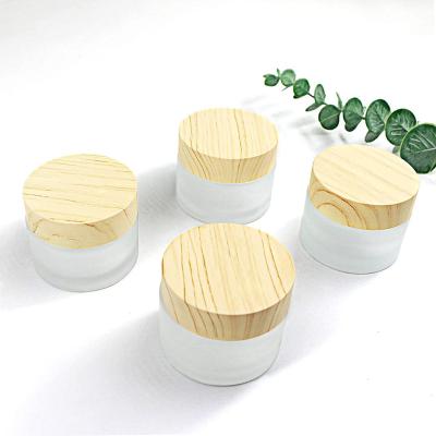 China 10ml 250g cosmetic empty round frosted straight sided cosmetic glass jar with bamboo lid 200ml face cream refillable jar for makeup for sale