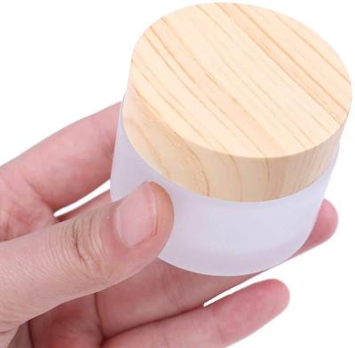 China Hot Selling 50ml Cosmetic 1.7oz Frosted Glass Bamboo Cosmetic Cream Jar Cosmetic Packaging Container With Bamboo Lid for sale