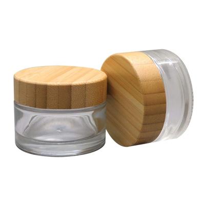 China 50g round cosmetic empty frosted straight sided transparent cosmetic glass jar face cream jar with bamboo lid for sale