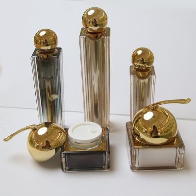 China Luxury Cosmetic Acrylic Square Pump Lotion Bottles And Jars With Ball Package For Cosmetics for sale