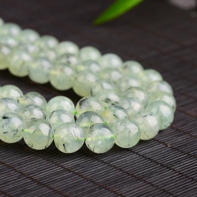 China Polished Genuine Natural Stone Prehnite Gemstone Polished Soft Loose Round Pearl Rutile Green Crystal Prehnite for sale