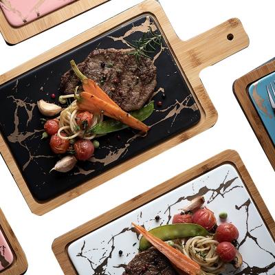 China Sustainable Use Gold Marble Design Ceramic Restaurant Steak Dish With Wooden Paddle for sale