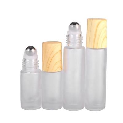 China Personal Care 5ml 10ml Frosted Roll On Glass Bottle Personal Perfume Round Roller Wooden Matte Ball Metal Cover Empty Bottle for sale