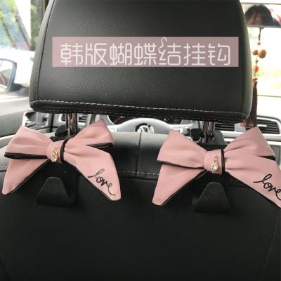 China Classic Car Vehicle Bowknot Backseat Headrest Hanger Holder Car Back Seat Wide Bowknot Hooks For Handbag for sale