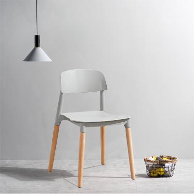 China Factory Supply Modern Wholesale Plastic Seat Dining Room Stacking Chair With Wooden Legs for sale