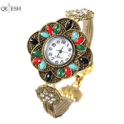 China Chronograph Qetesh Ladies Watches Women Wrist Gold Rhinestone Resin Strap Luxury Plated Ethnic Watch for sale