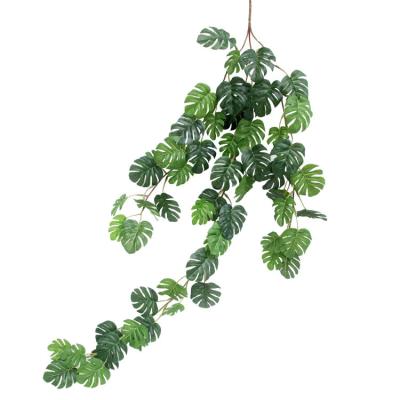 China Home Decor Artificial Plants Greenery Monstera Palm Leaves Hanging Vines Tropical Garland For Wedding Backdrop Arch Wall Decor for sale