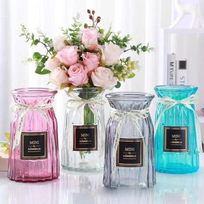 China Eco-friendly creative flower decoration bottle shape glass clear vase for home for sale