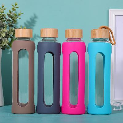 China Custom Logo 550ML Unbreakable Wide Mouth Viable Glass Water Bottle With Silicone Sleeve for sale