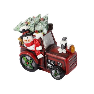 China Worlwide Christmas Gift Snowman Driving Car Christmas Tree Led Lights Resin Figure Custom for sale