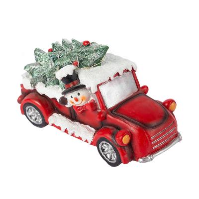 China Worlwide Snowman Driving Car Christmas Tree Led Lights Resin Christmas Ornaments for sale