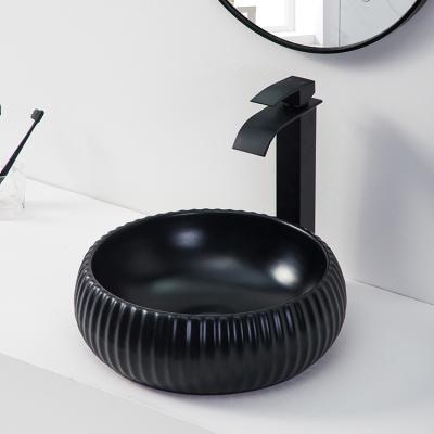 China Hotel modern single countertop lavamanos round hand basin ceramic matte black color bathroom sink for sale