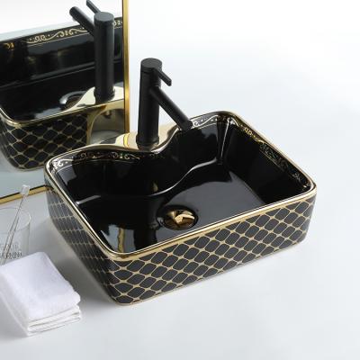 China Modern Luxury Gold Hand Art Wash Basin Porcelain Countertops Black Ceramic Sink For Bathroom for sale