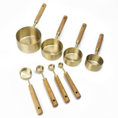 China Stocked Stainless Steel Gold Finished 8pcs Measuring Cups And Spoons With Wooden Handle for sale