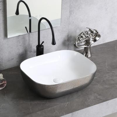 China Popular Professional Electroplate White Silver Art Counter Top Art Ceramic Wash Basin Hand Wash Basin Sink for sale