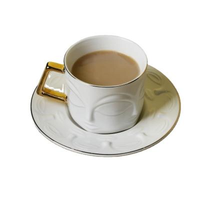 China Viable High Quality Fine Bone China Embossed Face Design Cup And Saucer Coffee Cup With Saucer White Cup for sale