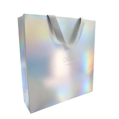 China Recycled Materials Fashion Logo Printed Luxury Custom Kraft White Laser Silver Paper Bag With Handle for sale