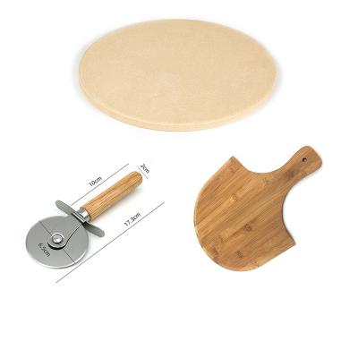 China Sustainable round cordierite ceramic pizza stone set with bamboo pizza paddle and wooden handle pizza cutter for sale