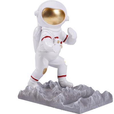 China Desktop Astronaut Mobile Phone Holder Resin Waterproof Funny Astronaut Style Phone Stand Holder for sale