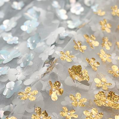 China 2021 breathable special glitter shinny to reflect light 3D gold silver foil mesh laser embroidery flower fabric for dresses for sale