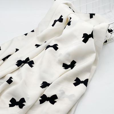 China Sustainable Modern Woman Custom Design Black White Bowknot Patterns Soft Chiffon 75d Polyester Printing Fabric for sale