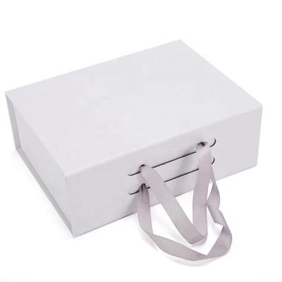 China Hot Sale Custom Recycled Magnetic Materials Girls' Clothing Packaging Box White Gift Packaging Boxes With Ribbon Handle for sale