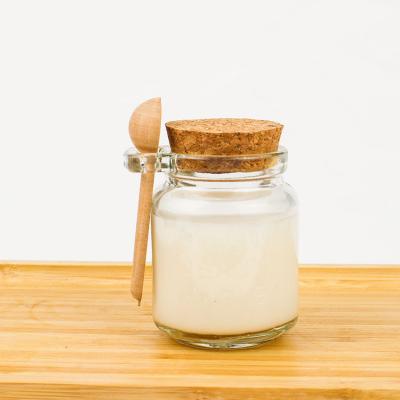 China Recyclable Kitchen 150ml Round Empty Clear Food Honey Storage Glass Bottle Jars With Wooden Spoon Lids for sale