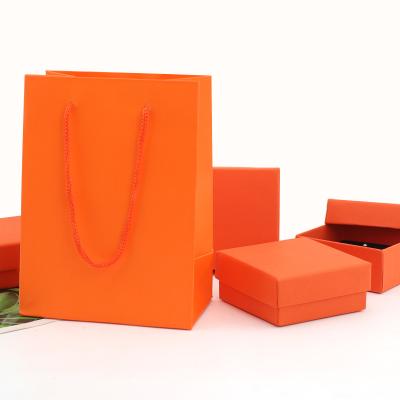 China Square Customizable Logo Orange Kraft Paper Jewelry Box , Special Gift Packaging Handbag for sale