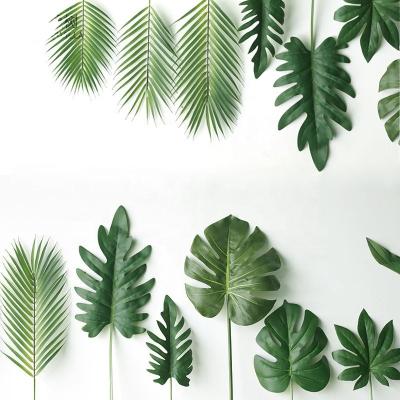 China Tropical Photography Plants Monstera Lea Decorative Palm Leaves Waterproof Artificial Green Silk Plastic Plastic for sale