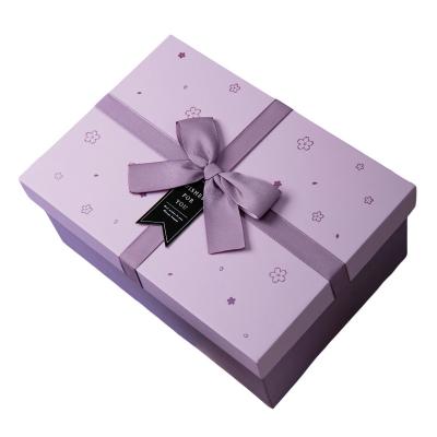 China Recycled Materials Packaging Custom Logo Cosmetic Package Rigid Ribbon Gift Box for sale