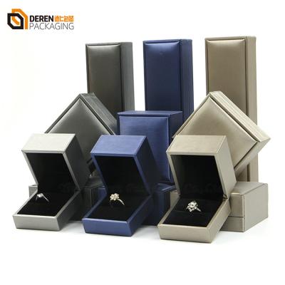 China Luxury Interior Silver Blue Leather Hinged Hinge Set Luxury Interior PU Gold Ring Bangle Earring Bangle Velvet Necklace Jewelry Box With Logo for sale