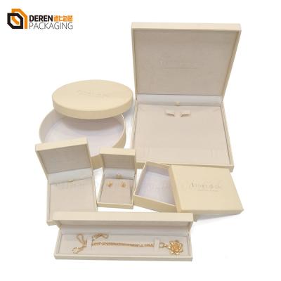 China Custom reliable luxury quality elegant beige hot stamp logo paper jewelry box ring bracelet earring necklace for sale